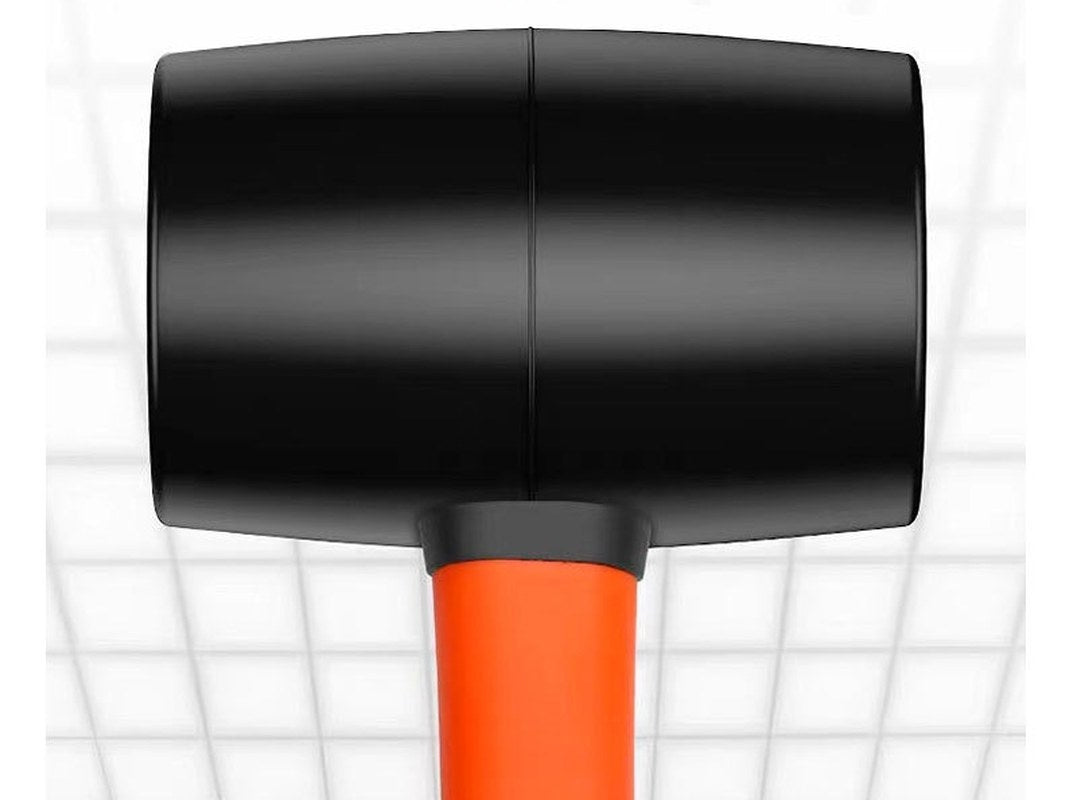 Close-up of the black mallet head, showing the seam between its two halves and the orange shaft