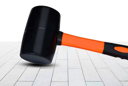 The mallet resting on a tiled floor, showing one flat striking face of the rubber-type head