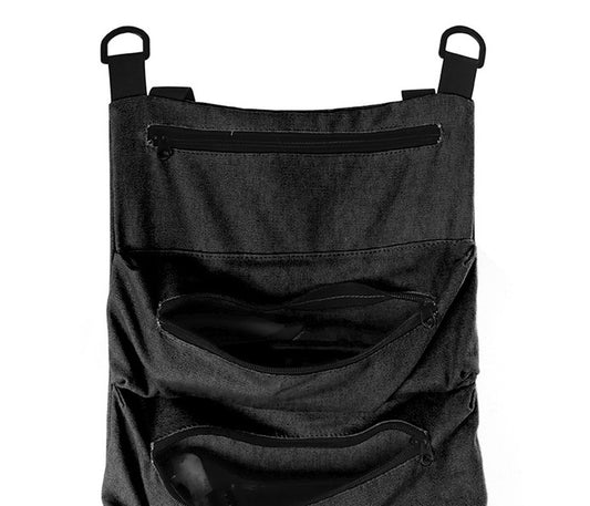 Close-up of the black tool roll: D-rings on straps, the top zipper pocket and the first gusseted pocket